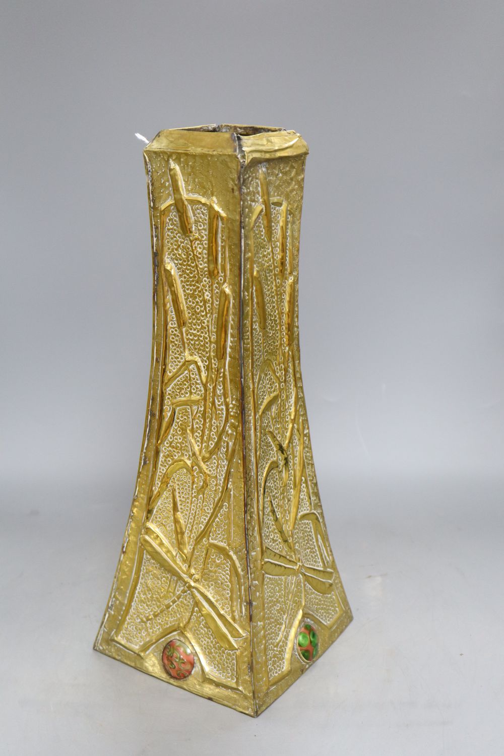 An Art Nouveau brass vase with multi coloured ceramic cartouches, height 40cm